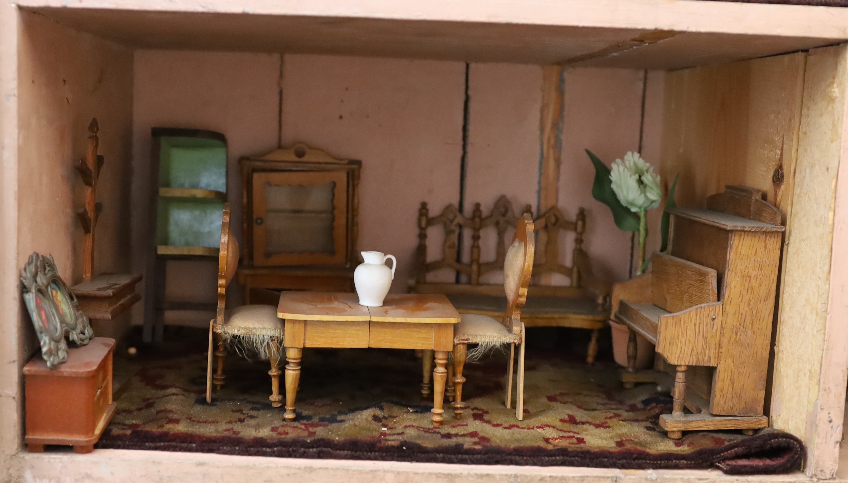 A Victorian furnished dolls’ house, circa 1890, 77cm high.